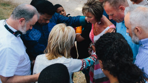 Alex Kendrick, Dr. Tony Evans, Beth Moore, Priscilla Shirer and Stephen Kendrick pray over the Mitchell family and ask God to bless their home in Jesus’ name (the Mitchell home served as filming location for the Jordan family). (Courtesy of AFFIRM Films/Provident 
