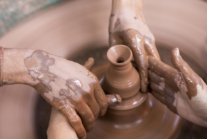 Two sets of hands - Potter teaching another